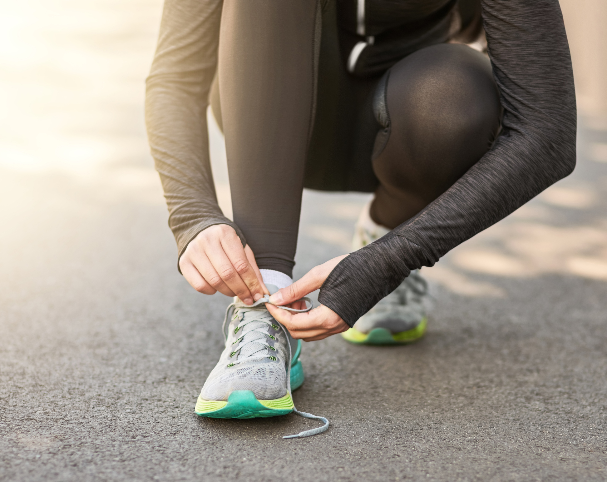Shot of an unrecognizable young woman tying her laces before a morning run